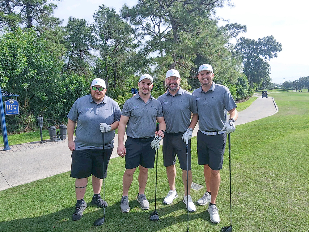 The Simple Logistics team of 4, standing together at a golf course