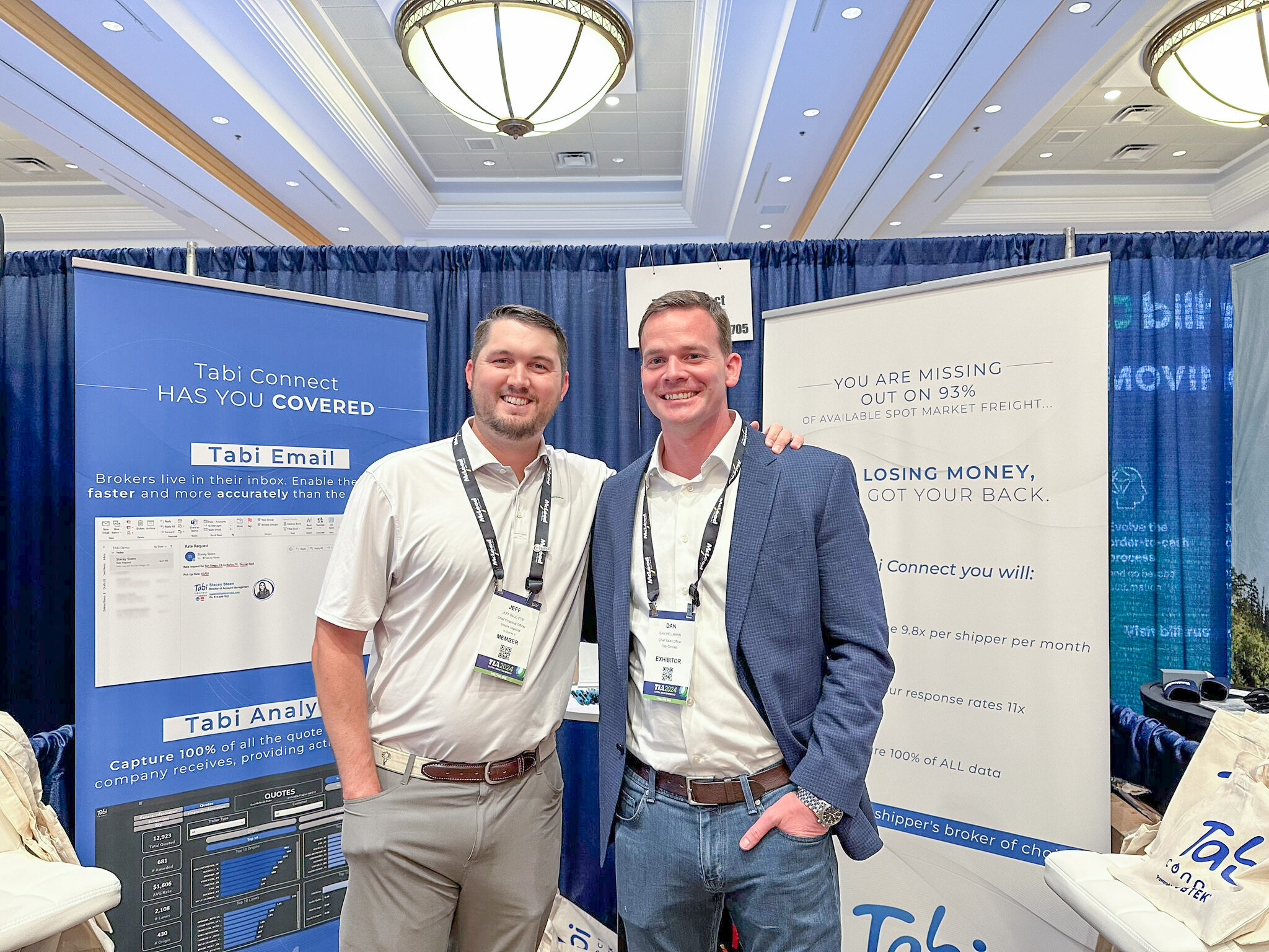 Jeff Paul stands with Dan Hellmann, CSO at Tabi Connect, in front of a booth at the FSA Conference